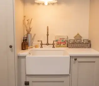 Cozy kitchen nook with a vintage feel, featuring a white farmhouse sink