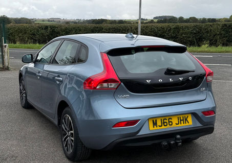 Rear three-quarter view of a blue Volvo V40 hatchback showing the tailgate
