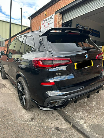 Close-up of the rear side of a clean black BMW X5 SUV