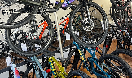 Selection of Cube mountain bikes on vertical display racks inside Hargreaves Cycles
