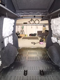 Van interior during conversion with insulation fitted inside the side panels
