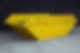 A clean, empty, yellow metal skip hire on a concrete floor