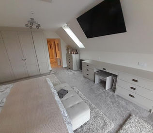 Spacious bedroom with a double bed, beige bedding