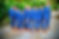 Groomsmen and a young boy in matching blue suits and brown shoes pose playfully
