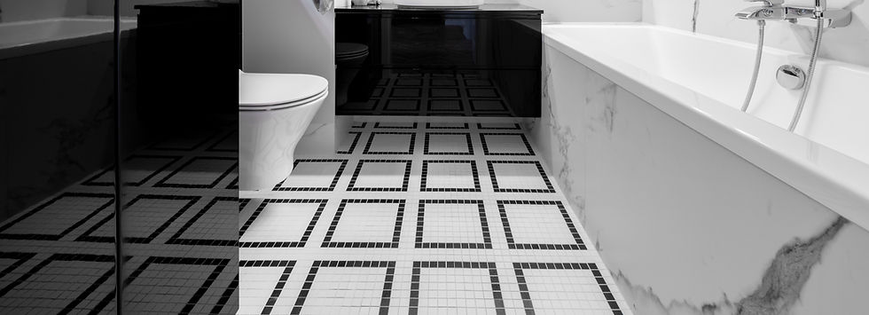Geometric black and white mosaic floor tiles in a contemporary bathroom
