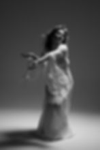 contemporary modern dance photography in a long white dress in a studio in brooklyn, new york city. ethereal dance movement photography with fan blowing in black and white