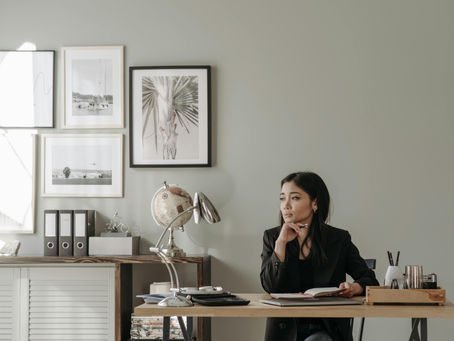 woman in a thoughtful, professional setting