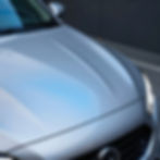 Polished silver car hood after professional auto detailing