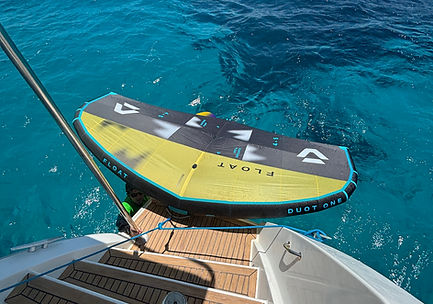 Wing floating behind catamaran