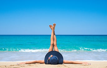 woman-lying-beach-with-legs-up-air.jpg