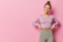 horizontal-shot-happy-sporty-woman-dressed-tracksuit-has-fit-healthy-body-looks-away-has-c