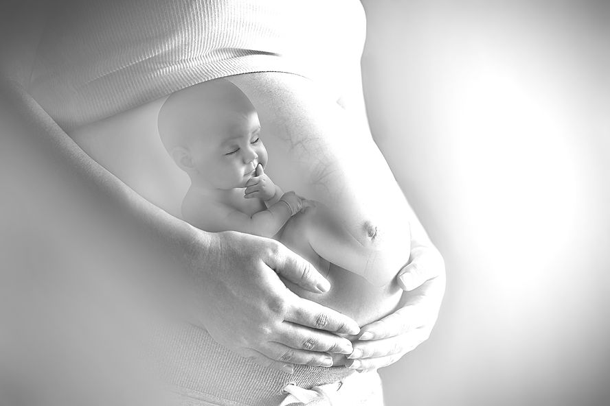 Pregnant woman's belly closeup with a baby inside, conceptual motherhood image_edited.jpg