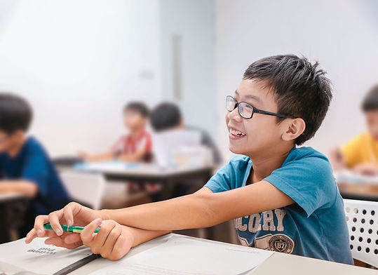 Primary school boys listening attentively in his English Tuition Class.