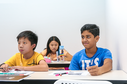 Secondary School students listening attentively to their teacher during their English Tuition Class.