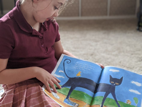 She loves to read to her siblings during circle time (Sept 2020).