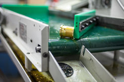 Parts exiting CNC Lathe