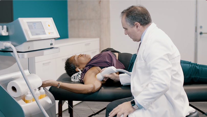 SoftWave doc treating woman lying down.png
