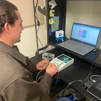 A person holds the electrodes during their scan.