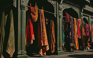A vibrant travel scene in India, rendered in dark olive green and bronze tones. The image