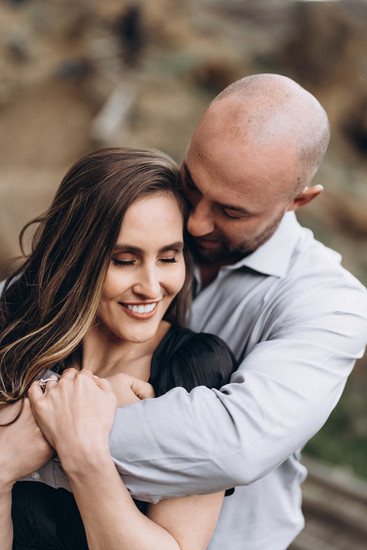 The guy is hugging the girl