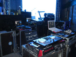DJ working on music equipment with Pioneer DJ controller at music event