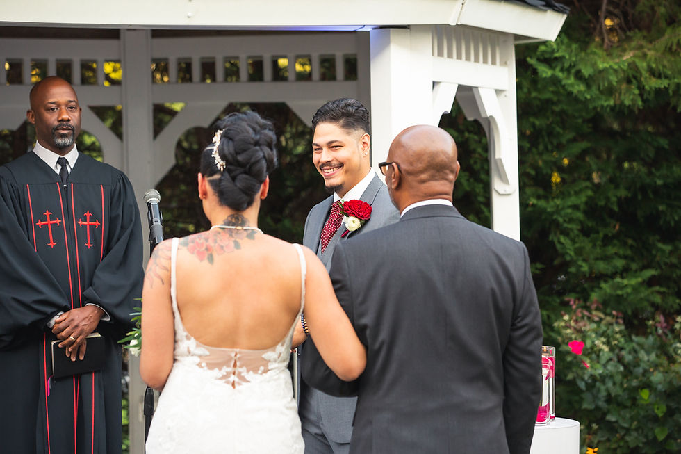 Bride meeting the groom at the alter during the wedding ceremony at Martin's Crosswinds in Greenbelt, Maryland.