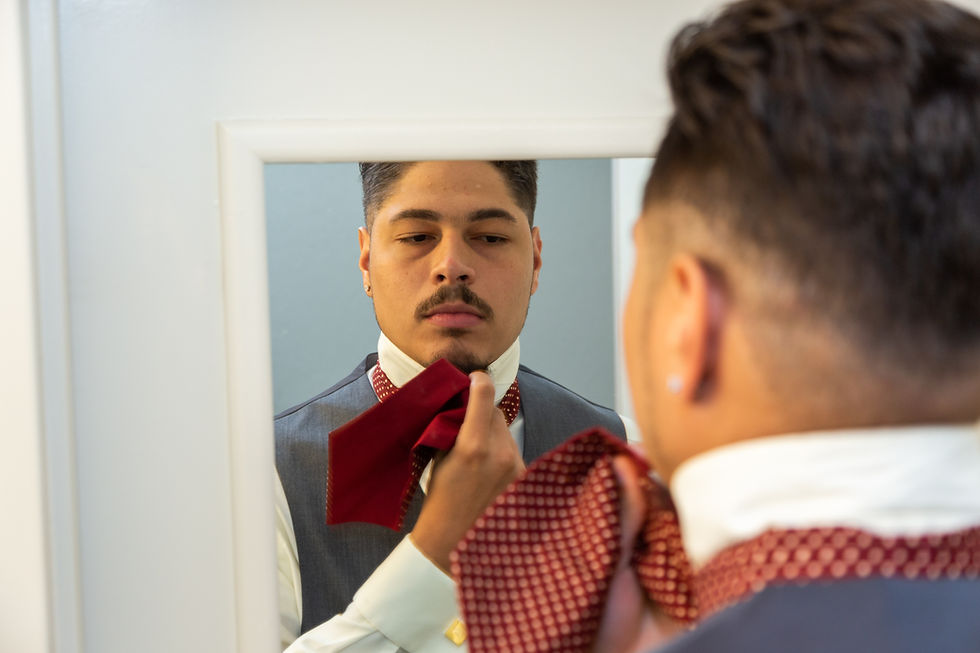 Groom preparing ascot on his wedding day before the wedding ceremony at Martin's Crosswinds in Greenbelt, Maryland