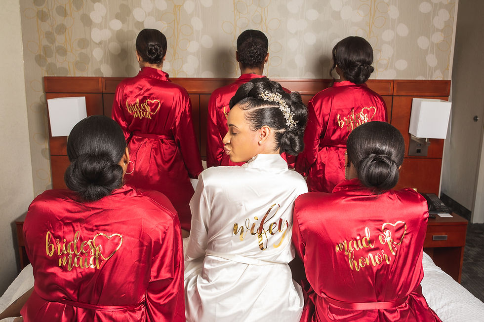 Bride and her bridesmaids showing off their custom bridal robes before the wedding at Martin's Crosswinds in Greenbelt, Maryland.