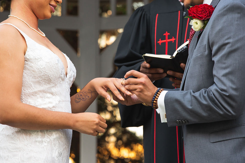 Groom placing the bride's wedding band on her finger during the wedding ceremony at Martin's Crosswinds in Greenbelt, Maryland.