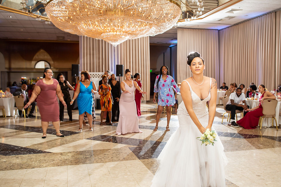 Bride tossing the bridal bouquet during the wedding reception at Martin's Crosswinds in Greenbelt, Maryland.