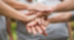 Hands on top of one another working together as a team