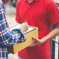 young-man-delivering-package-to-customer-at-home-delivery.jpg