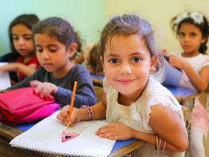 Young girl holding pencil