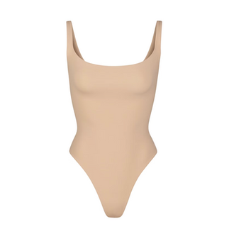SKIMS nude bodysuit with a smooth, second-skin fit and minimalist design, creating a seamless and sculpted silhouette