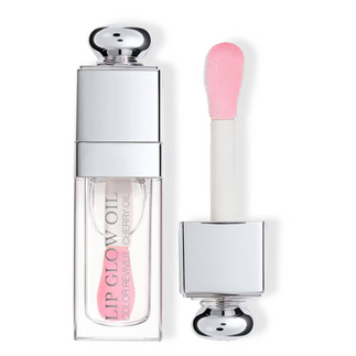 Clear Dior Lip Glow Oil applied over the lips, creating a glossy mirror like shine with a smooth, plumped appearance and a hydrated, natural finish.