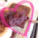 A slice of chocolate hidden veggie brownie with a pink loveheart drawn around it