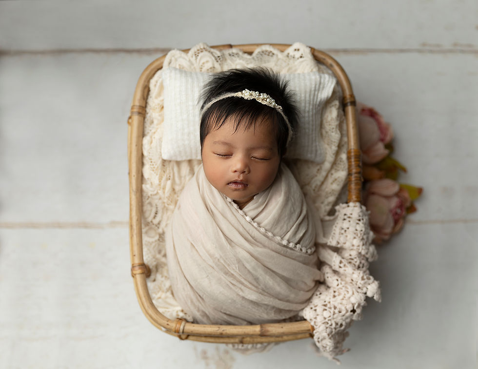 Close-up view of a soft blanket draped over a delicate newborn prop