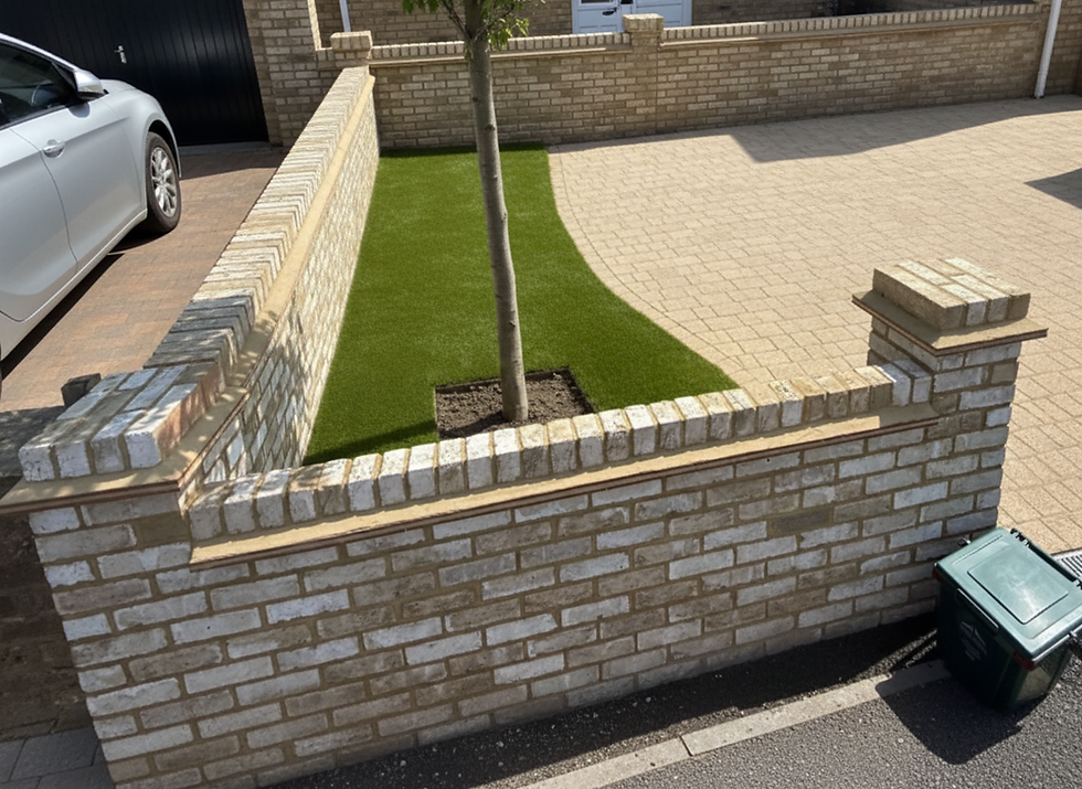 Garden brick wall with grass and paved area
