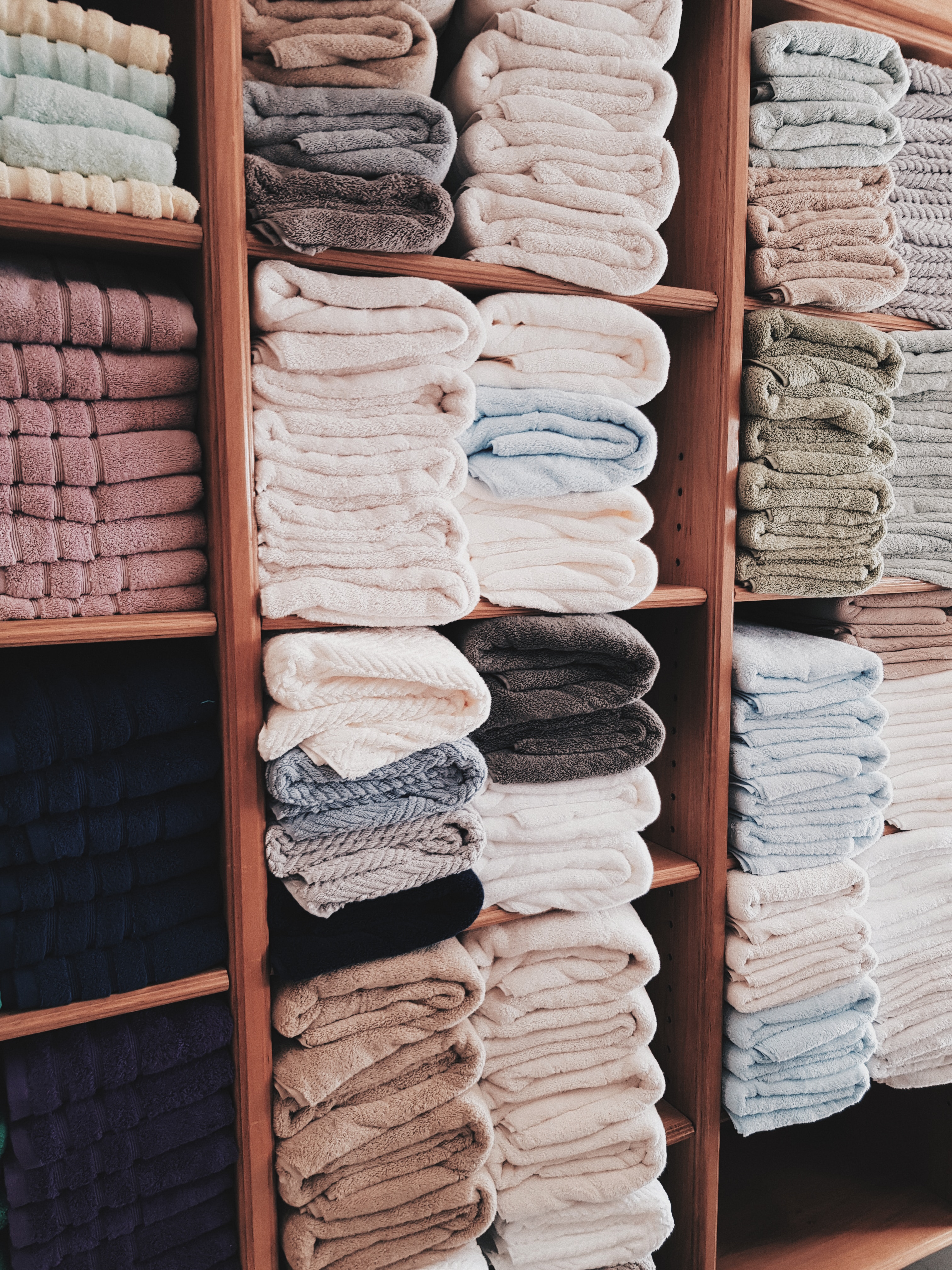 Hotel textiles on a clothing rack in a laundry room