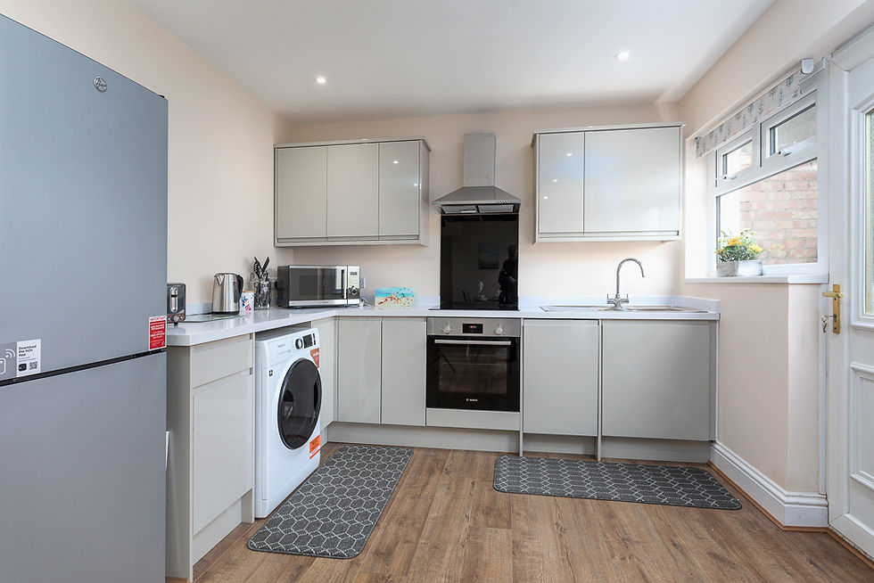 Modern kitchen with sleek grey cabinets, integrated appliances, and a bright, airy feel.