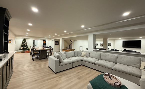 Spacious modern finished basement showcasing quality basement refinishing services.