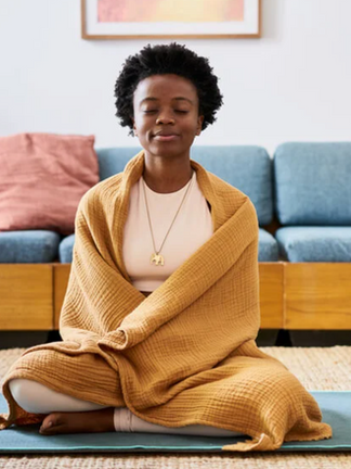 A woman practicing self-care through meditation