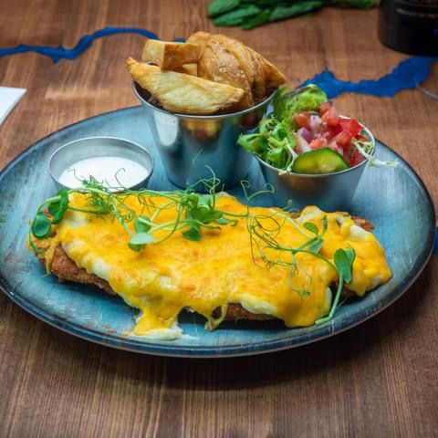 Chicken Parmesan with wedges and a salad.