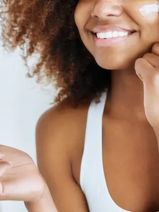 A woman moisturizing to fight inflammation 