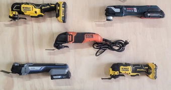 Five multi-tools of various brands (DeWalt, Bosch, etc.) on a wooden surface. Tools are in black, yellow, orange, and blue colors. No action.