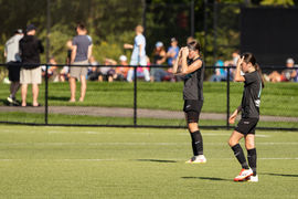 14U Girls Soccer game - one team in black and the other light blue - morning game