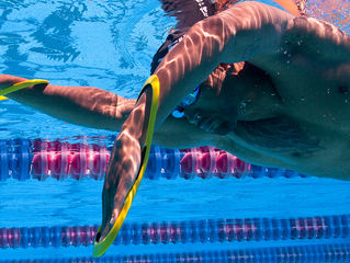 Why should you swim front crawl with an Early Vertical Forearm position and what does it help with?