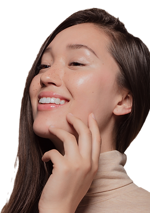 a woman with clear, bright skin smiling and touching her face