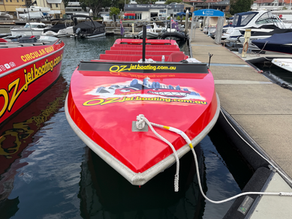 Red Oz Jet Boat with new vinyl graphics installed at Rushcutters Bay Marina