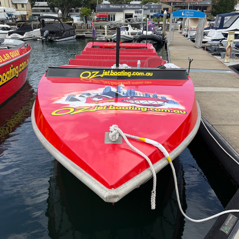 Red Oz Jet Boat with new vinyl graphics installed at Rushcutters Bay Marina